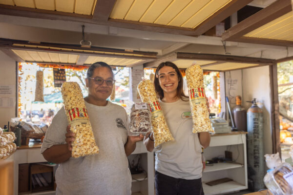 Event Cashiers holding bread and kettle corn