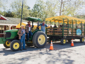 Tractor drivers wave on the hay ride at Irvine Park Railroad's Easter Eggstravaganza