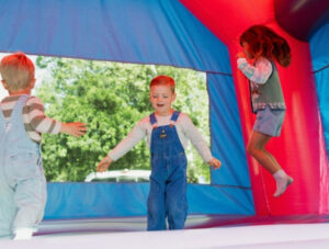 Children jump inside of a moon bounce at Irvine Park Railroad's Easter Eggstravaganza