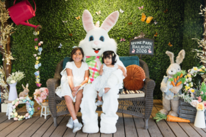 Two children taking photos with the Easter Bunny at the 2026 Easter Eggstravaganza at Irvine Park Railroad