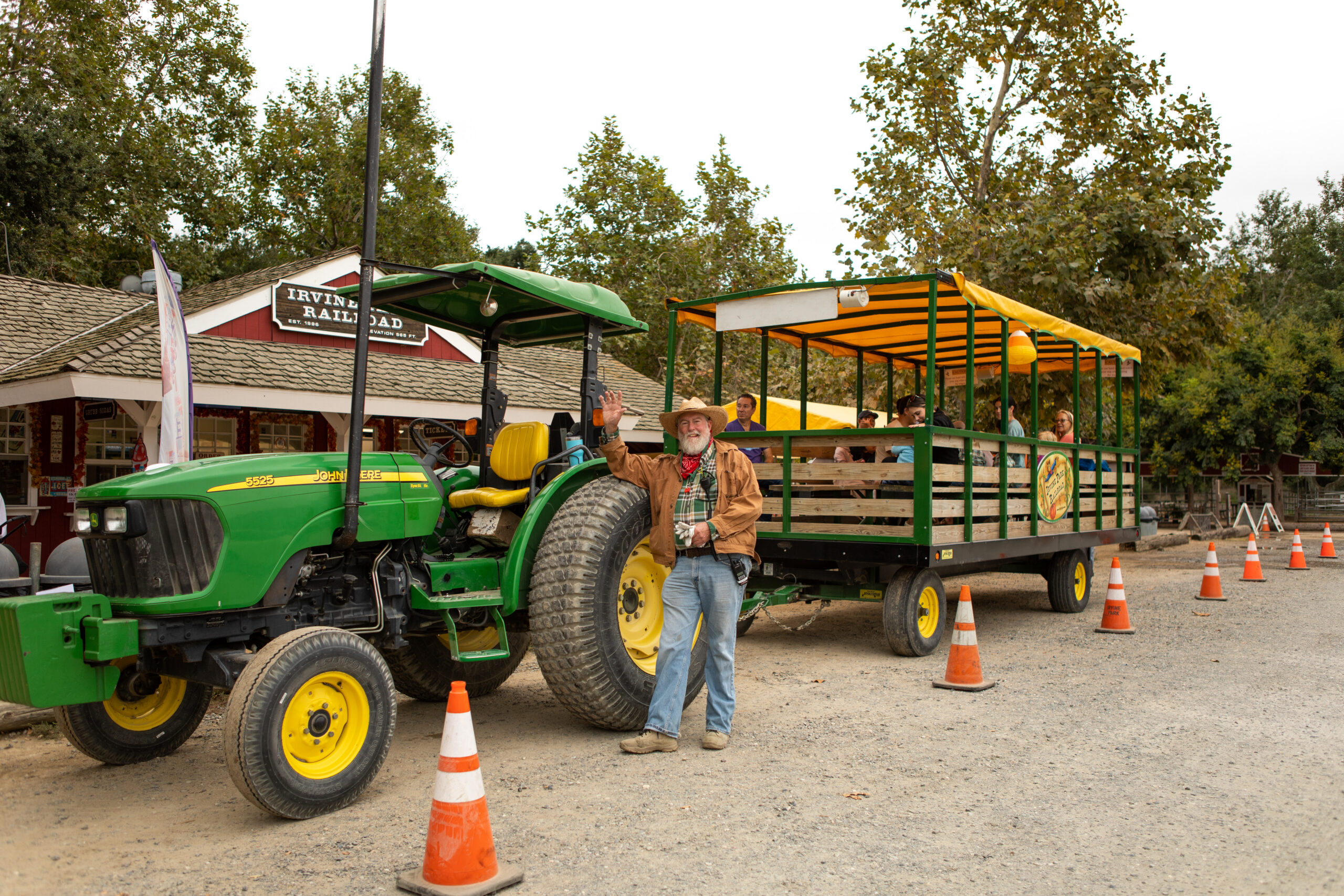 Hay Wagon Driver Waving in front of a John Deere Tractor